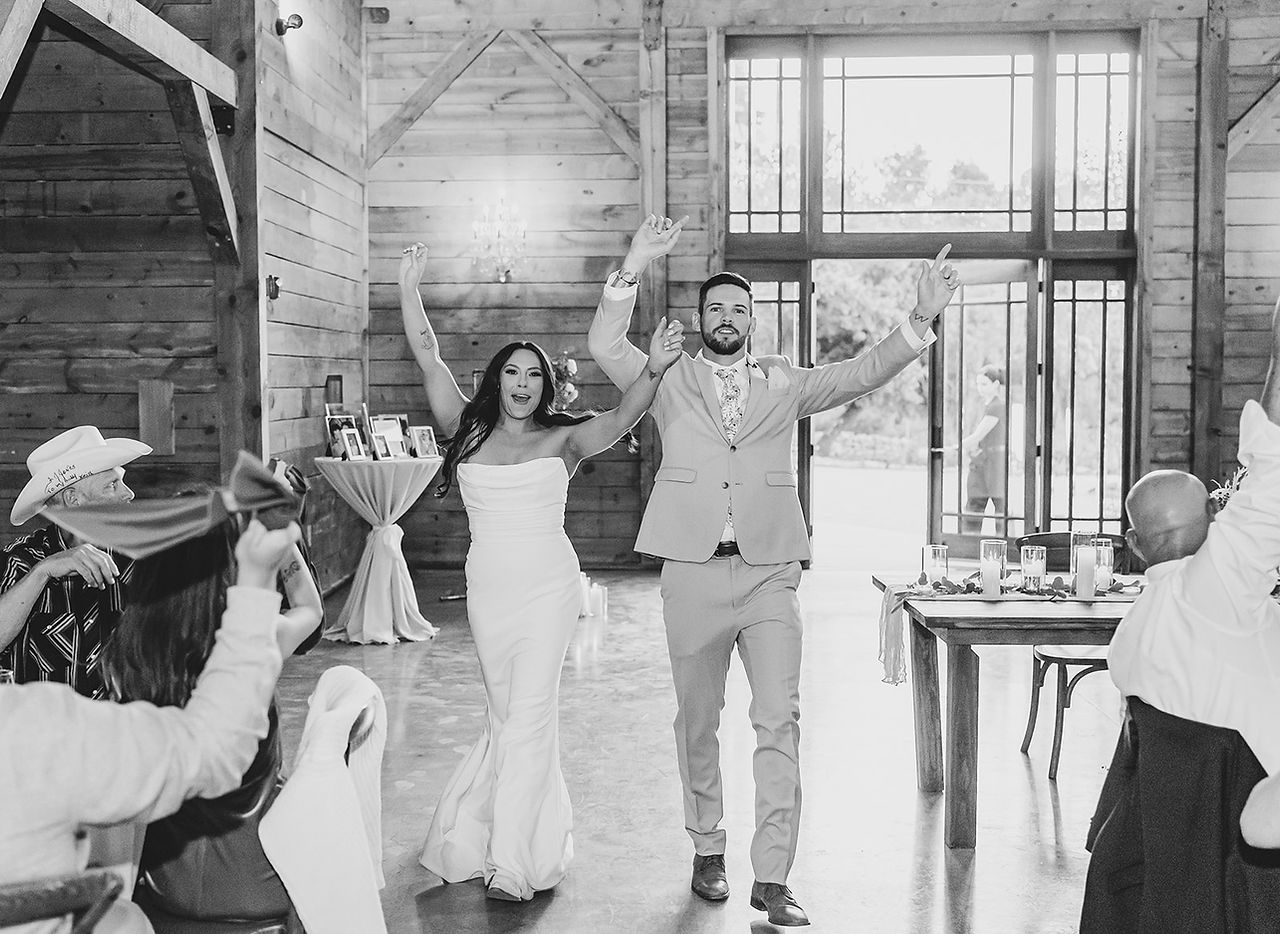 Bride and groom making their reception entrance at The Addison Grove in Dripping Springs, Texas, photographed by Grace J Photo.