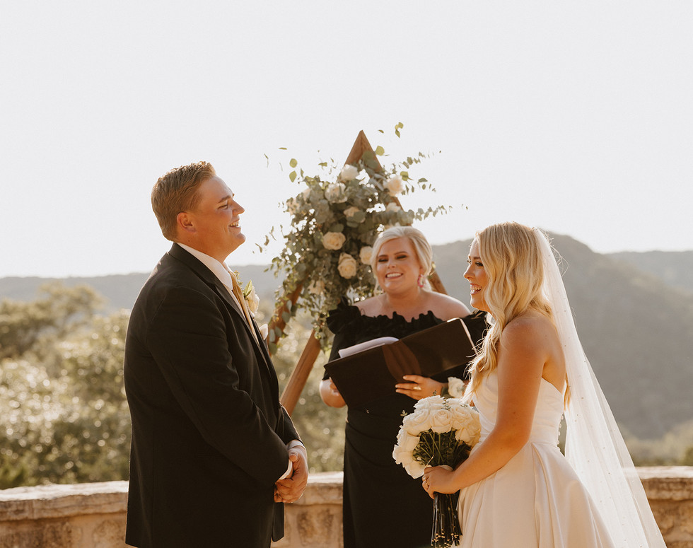 Bride and groom laughing together during their wedding ceremony at a private ranch in the Texas Hill Country, Texas