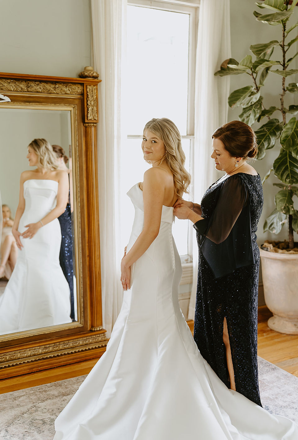 Bride getting dressed with her mom at Barr Mansion, photographed by Grace J Photo, Austin wedding photographer