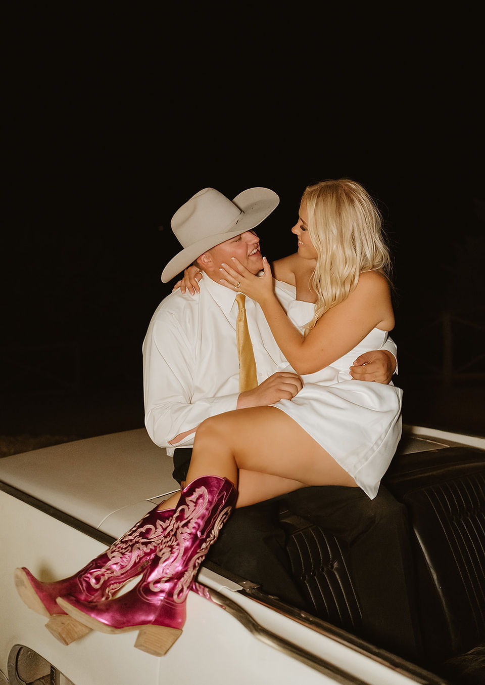 Bride and groom leaving in a vintage car at the end of their private ranch wedding in the Texas Hill Country, Texas
