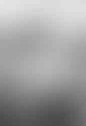 Couple wrapped in each other’s arms in a golden field during their Hill Country engagement photos.