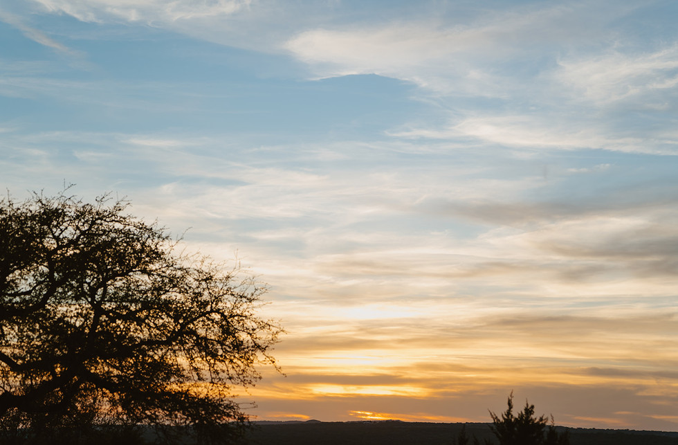 Wide shot of sunset over Hill Country landscape at Walden Retreats in Johnson City, Texas wedding