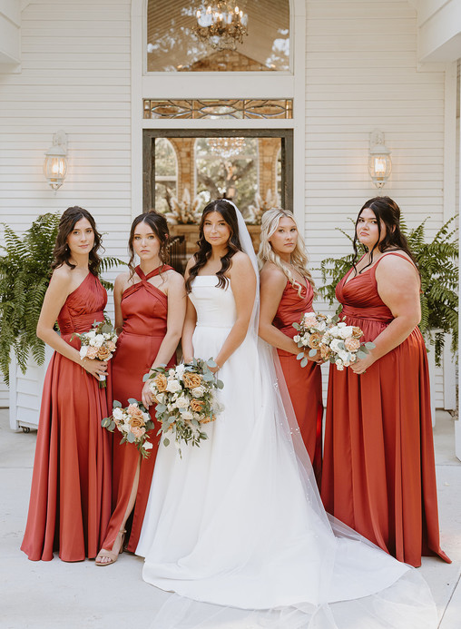 Moody portrait of the bride and bridesmaids together at The Chandelier of Gruene in Gruene, Texas.