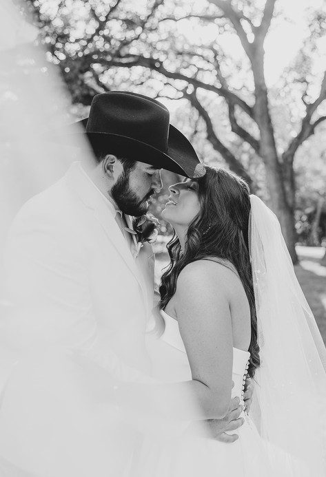 Black and white portrait of the bride and groom sharing a romantic moment at The Chandelier of Gruene.