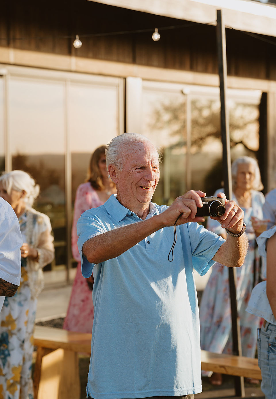 Grandfather taking photos during reception at Walden Retreats in Johnson City, Texas Hill Country wedding