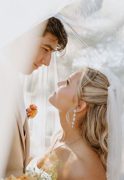 Bride and groom under the veil looking into each other’s eyes, Fredericksburg wedding photographer, warm Texas wedding photographer