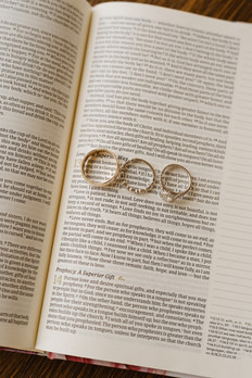 Wedding rings styled on a Bible during detail photos at Camp Hideaway in Fredericksburg, Texas