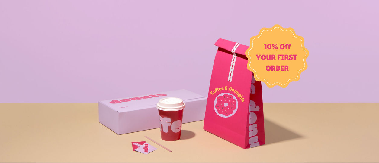 Promotional image of a branded coffee cup and branded packaging, highlighting the importance of brand identity and integrated marketing