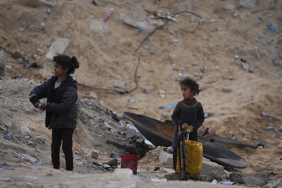 Displaced Palestinian girls fill a plastic jerrycan with water at a school by UNRWA, the U.N. agency helping Palestinian refugees, which they use as a shelter west of Gaza City, Sunday, March 9, 2025 (AP Photo/Jehad Alshrafi)