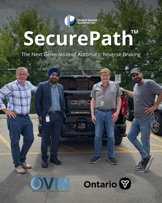 Global Sensor Systems team members with an OVIN representative standing outdoors beside the SecurePath automatic reverse braking system.