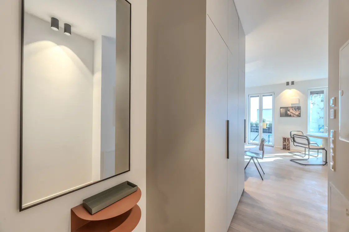 Entrance hallway with mirror and fitted wardrobe leading to the living area, Frankfurt
