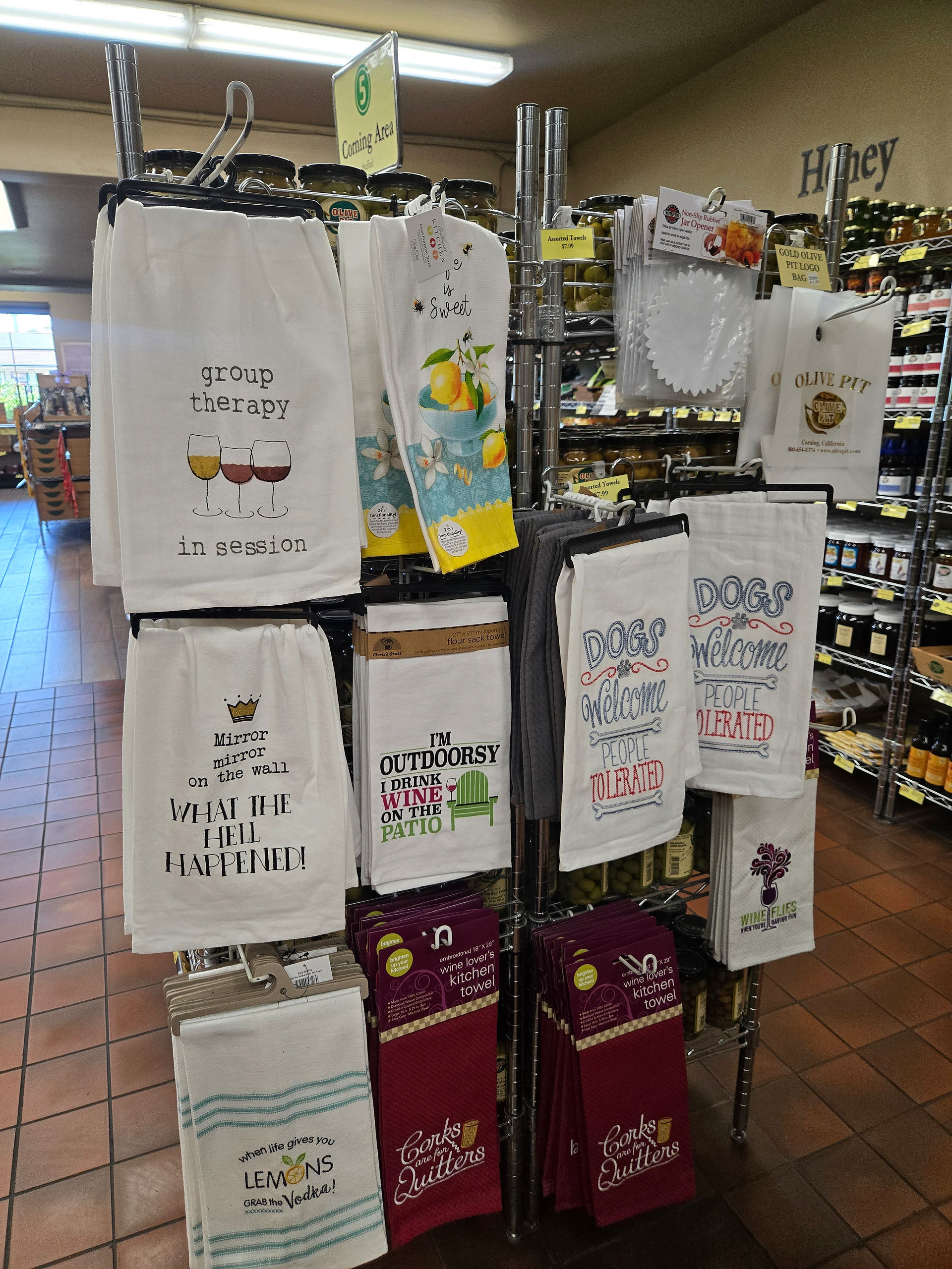 Funny and decorative kitchen towels on display at the Olive Pit gift shop in Corning
