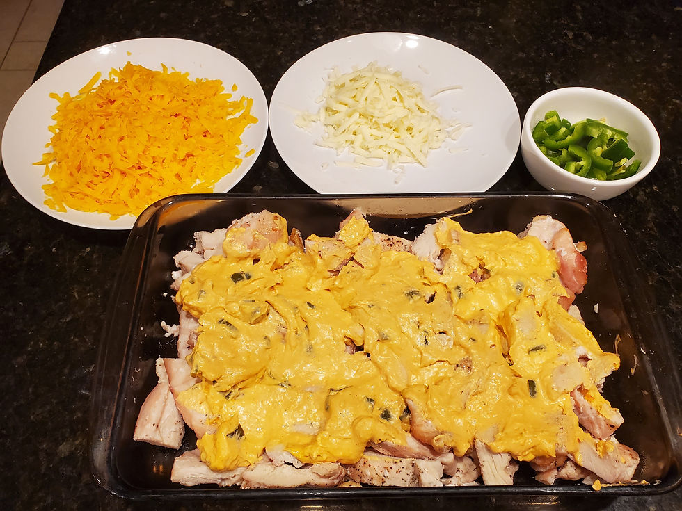 Creamy jalapeño cream cheese sauce spread over baked chicken breasts