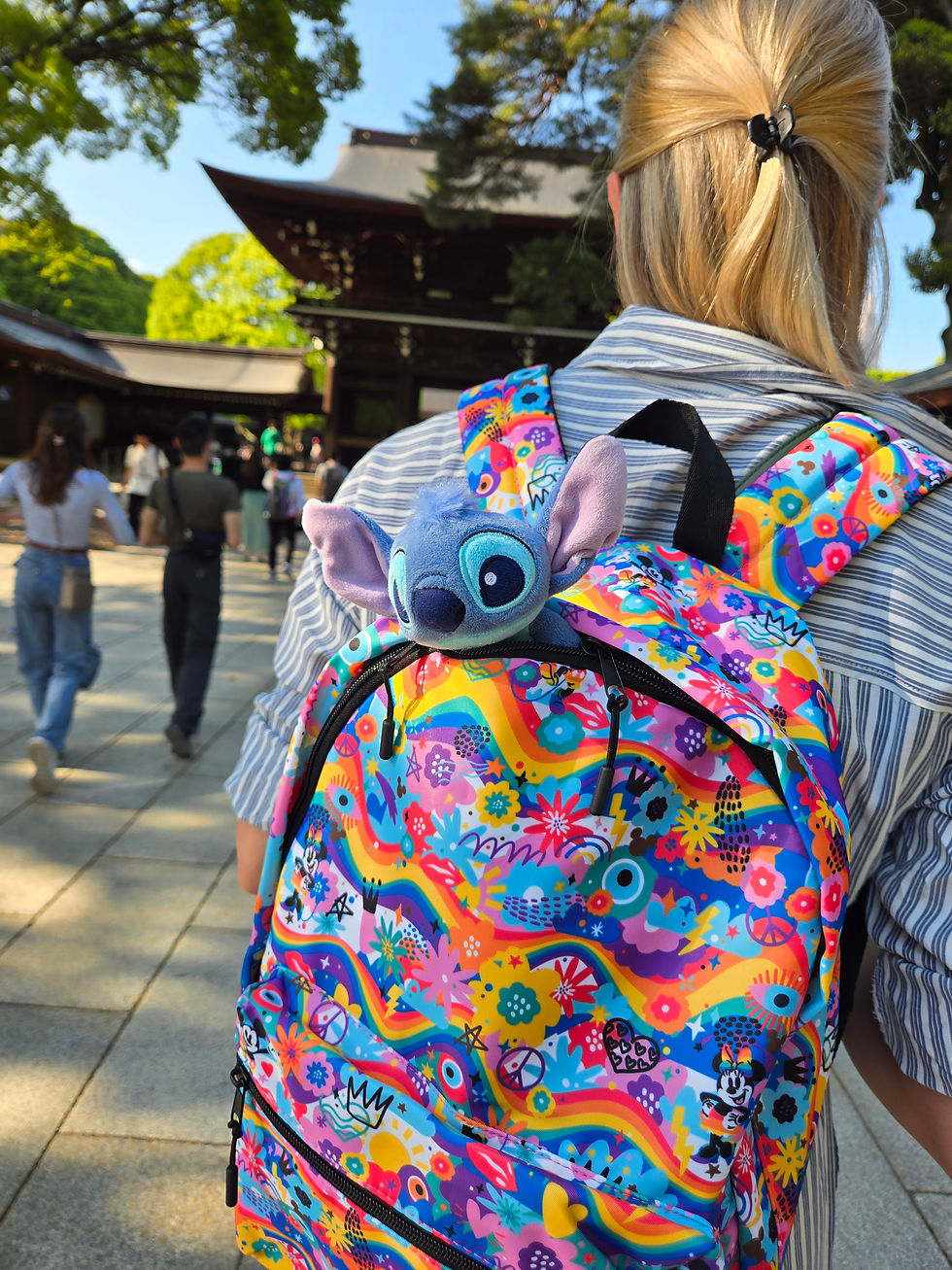 Little Blue 626 plush peeking out of a colorful backpack, ready for adventure.