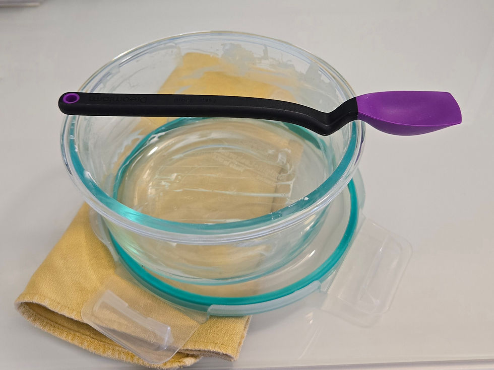 Purple Dreamfarm Mini Supoon silicone spoon scraper resting on glass bowl