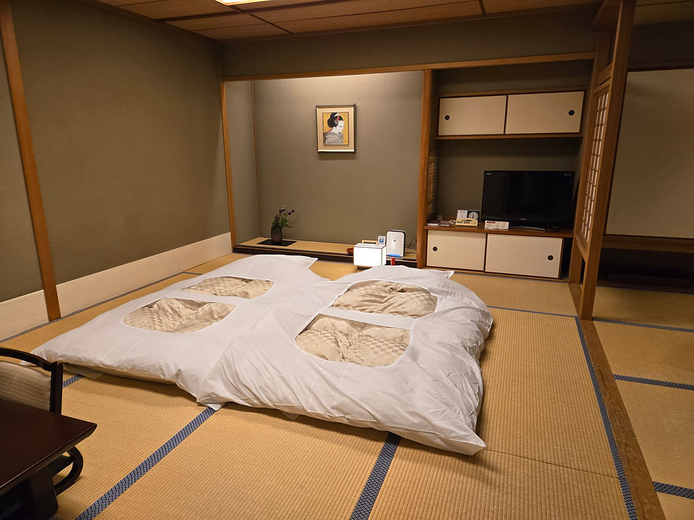 Futon bedding laid out on tatami mats at Nishimuraya Hotel Shogetsutei, with traditional yukata robes folded neatly beside.