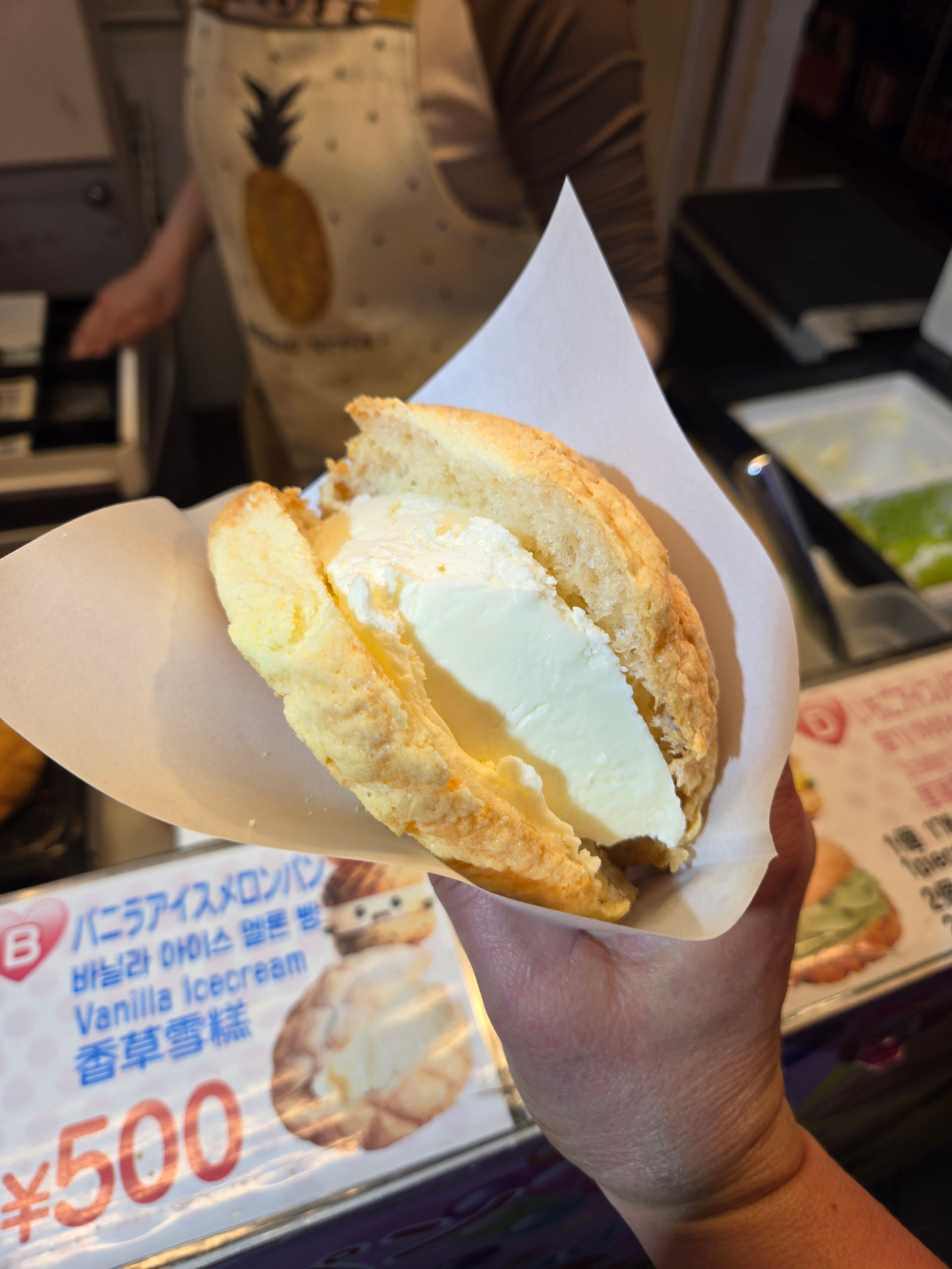 Melon pan ice cream sandwich with vanilla ice cream in Dotonbori Osaka.