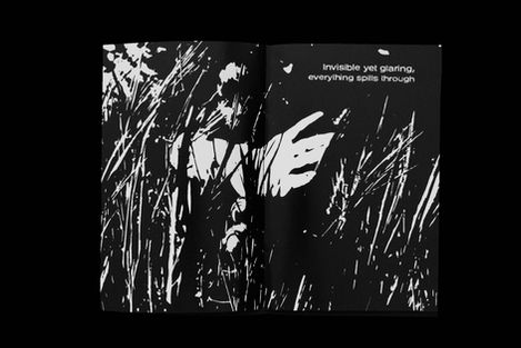 Black and white print of figure in abstract grass with text