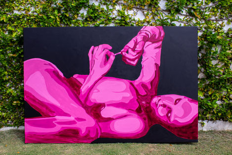 Vibrant pink reclining figure painting, dark background, green ivy wall outdoors.