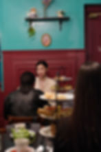 Women enjoying afternoon tea at a quaint tea room