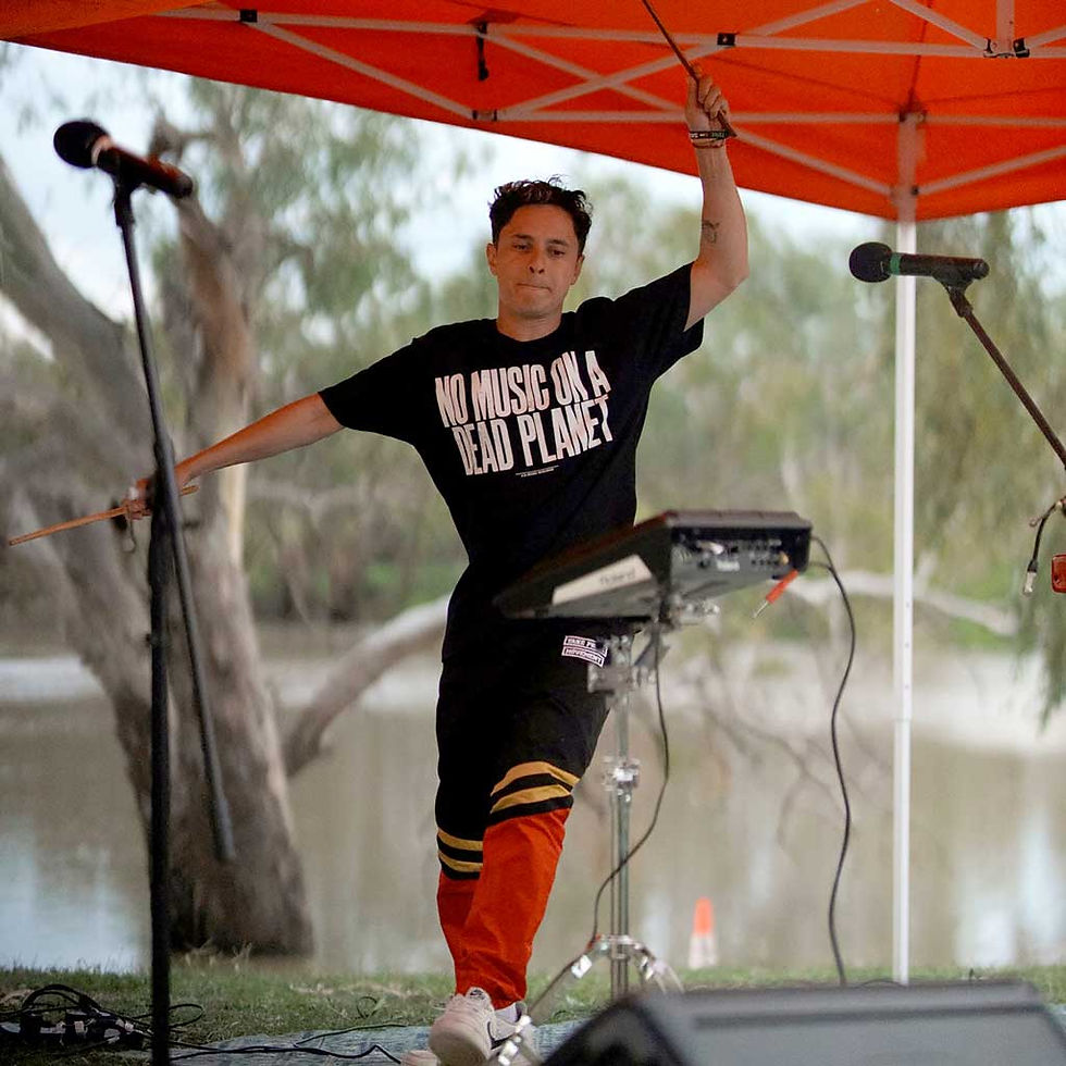 Pictured in front of the Barwon River, Rhyan Clapham, better known as music sensation DOBBY, shared his love of Country and music at Brewarrina last week. Photo TWH