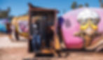 Lightning Ridge artist John Murray with some painted opal mining agitators, part of a growing project bringing other artists and new street art into the town. Photo: Beverley Callow