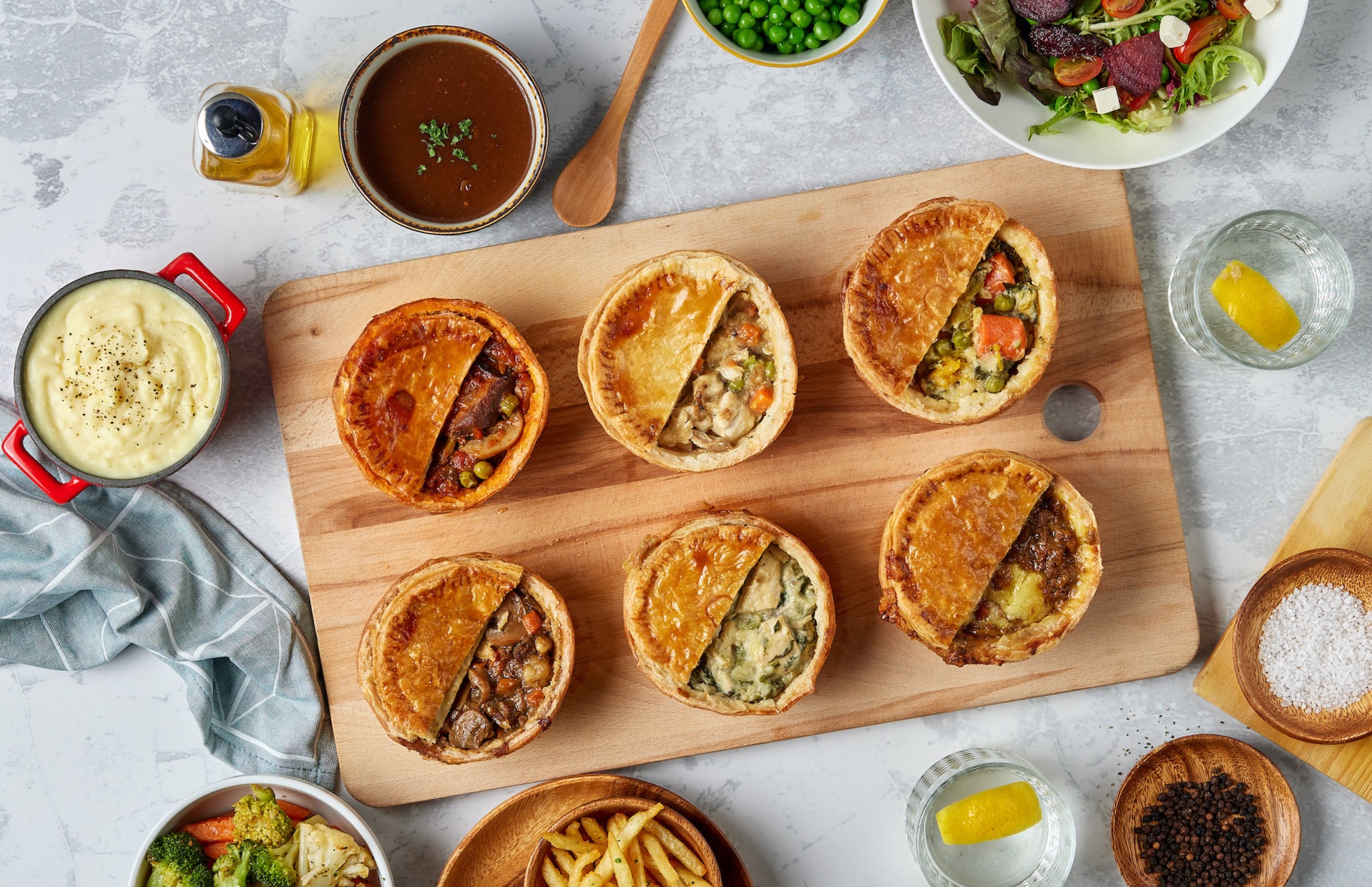 six pot pies with mash, gravy and sides at Dave's Deli