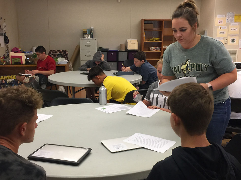 Miss Sandberg passing out a quiz.