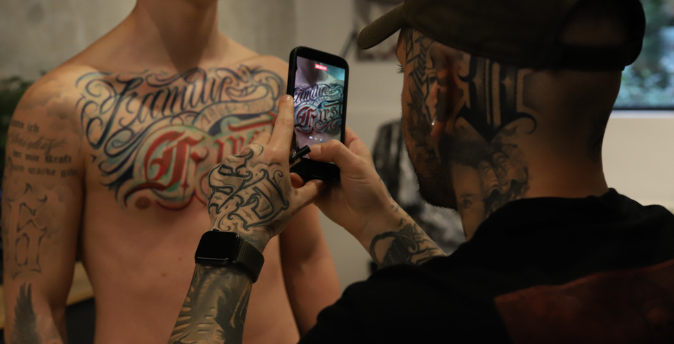 Large freehand lettering tattoo across the chest created at Bad Habits Tattoo Studio Karlsruhe