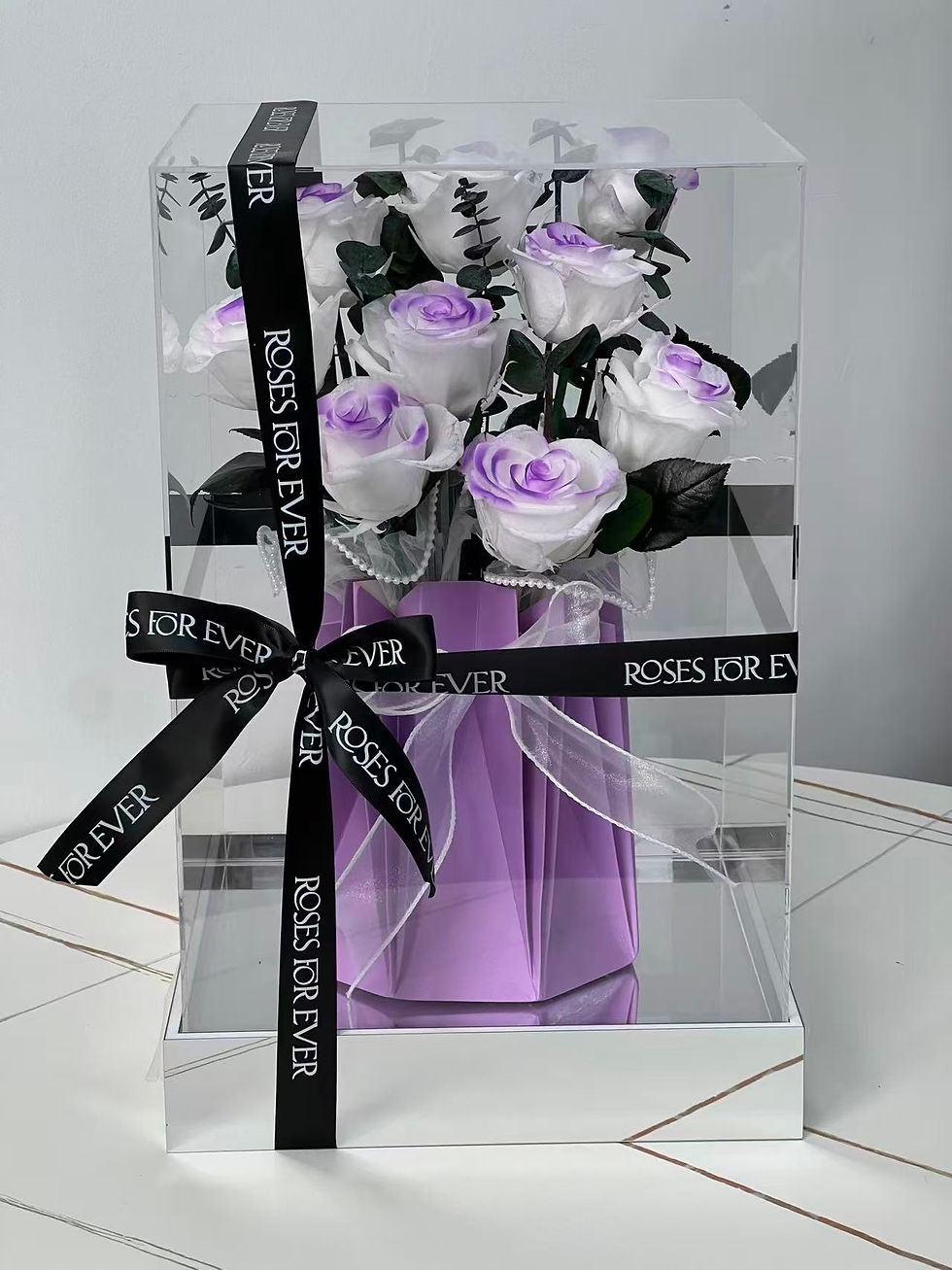 The Showcase Lavender preserved roses in an acrylic display box