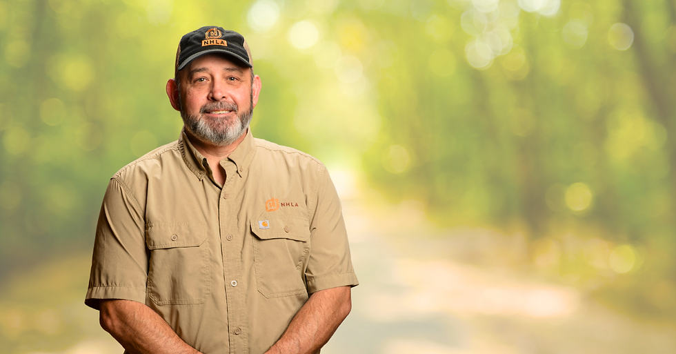 image of national inspector benji richards on top of a blurred forest background