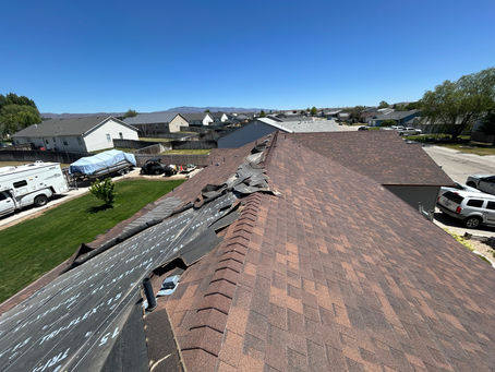 A windstorm in Mountain Home, Idaho damages a roof, necessitating a full replacement.