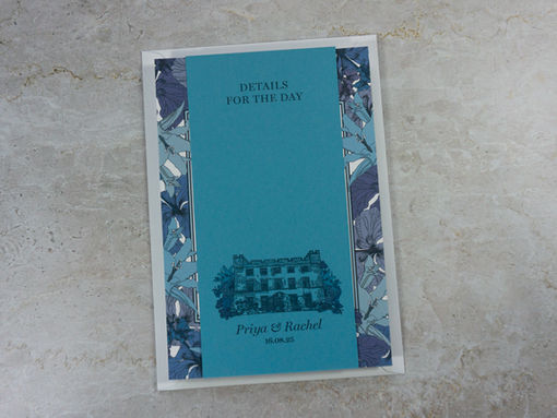 Eco-conscious Botanical Jewels invitation and details card, printed on a range of white and blue card stocks, styled on a grey concrete background