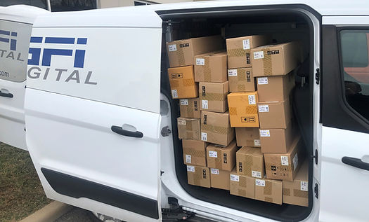 White van with boxes inside and "GFI DIGITAL" text on the side.