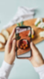 hand with phone and figs