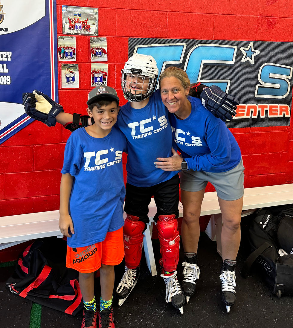 Hockey coach and two smiling boys, one in full gear