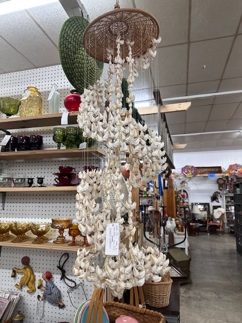 A white shell chandelier or wind chime (?) we're not exactly sure.