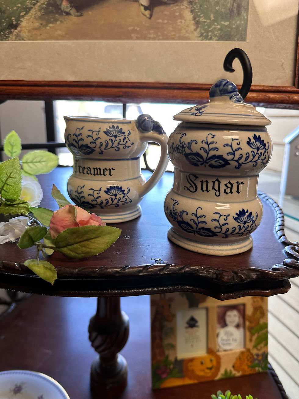 Two jars, one reading 'creamer' and the other 'sugar' in the pattern and shape of Blue Onion.