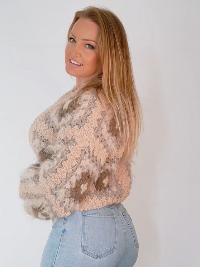The Nuvve Cardigan photographed from the side, showing soft volume and tonal beige color transitions.