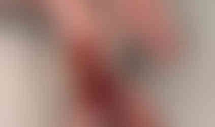 Three loops visible on the crochet hook after pulling up a loop, preparing to continue the double crochet stitch.