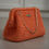 Thumbnail: CELESTE CLUTCH in shimmering orange pastel color Hallestam Design