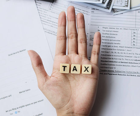 tax-words-on-palm-hands-against-the-tax-forms-2025-01-28-01-23-02-utc (1).jpg