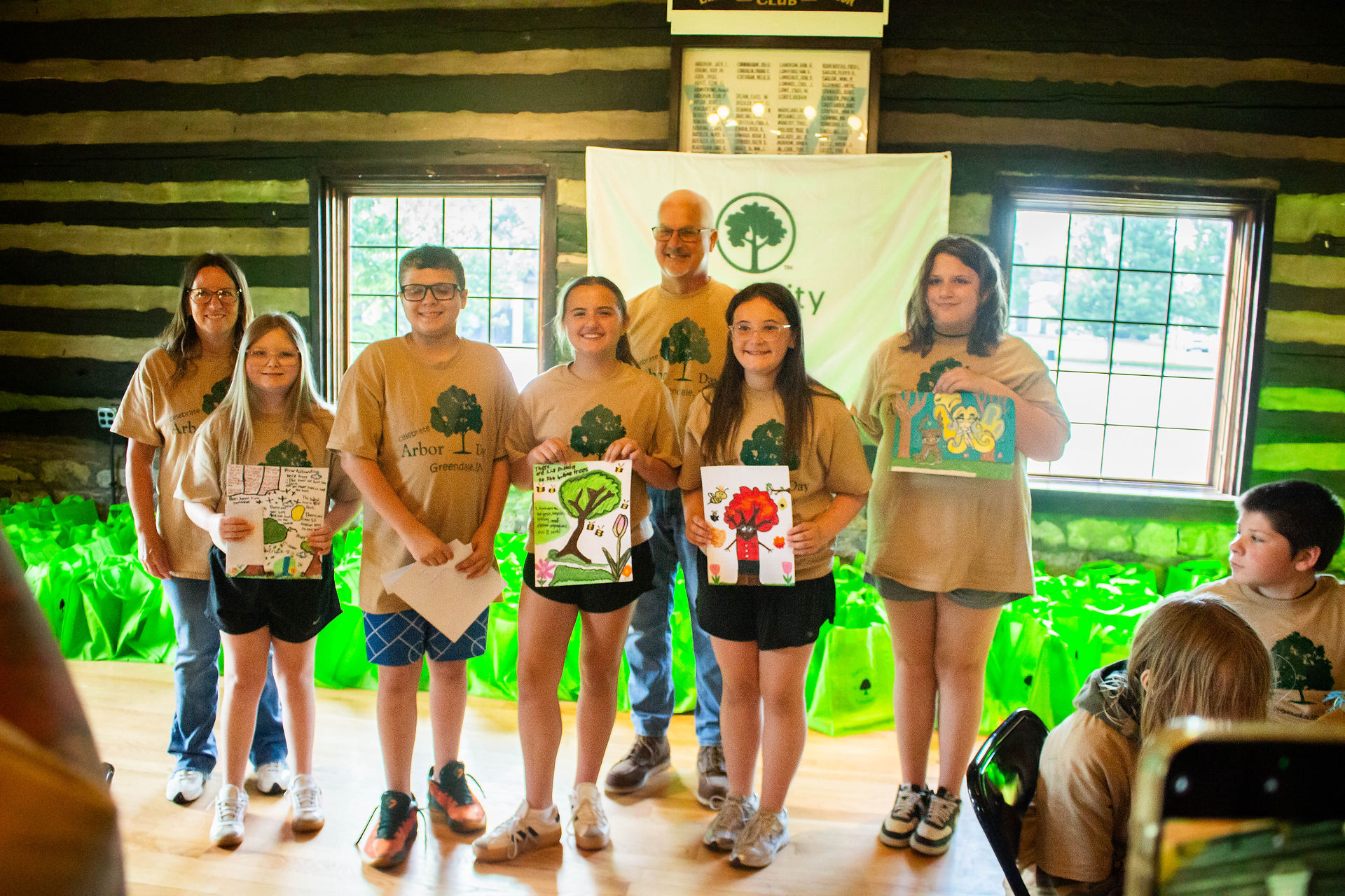 Fifth-Grade CES students stand with Mayor Vince Karsteter with their Arbor Day Posters