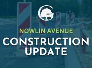 Road construction update graphic with striped barricades on a street, reading NOWLIN AVENUE CONSTRUCTION UPDATE.