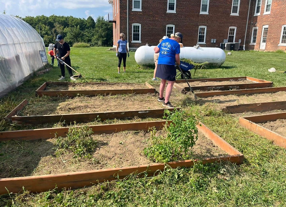The YES Home Volunteers Working the Garden Outside