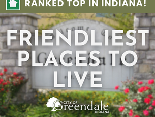 Friendliest Places to Live image, ranked top in Indiana, with blurred stone sign and colorful flowers in the background. Mood is welcoming.