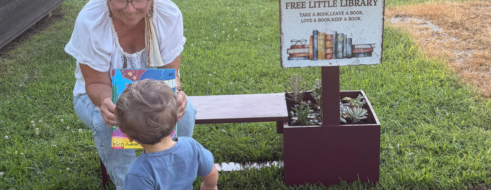 Presenting a book from the little library to a child.
