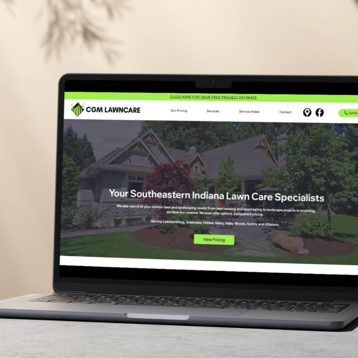 Photo of the CGM Lawncare website on a laptop sitting on a desk in a room.