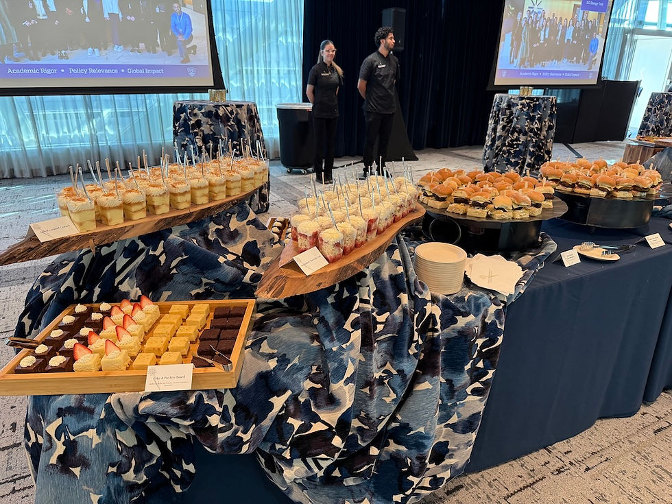 Dessert and slider station catered by Founding Farmers Co. Catering & Events at Johns Hopkins University's student welcome reception at the Bloomberg Center in Washington, DC, featuring a Cake and Pie Bite Board, Salted Caramel Custards, Strawberry Shortcake Cups, and Baby Smash Cheeseburger sliders