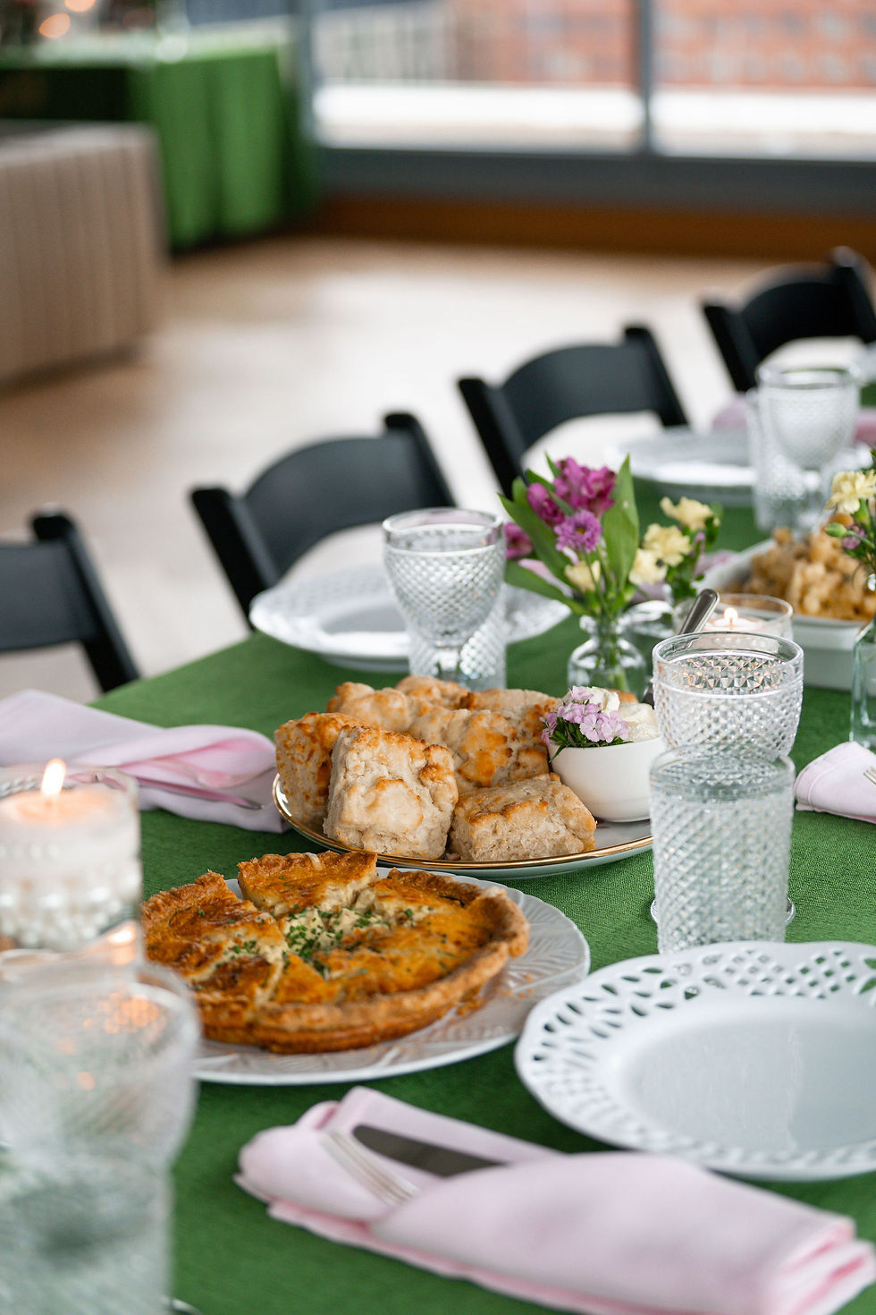 Example of family-style catering with scratch-made quiche, biscuits, and shared platters on an elegant event table setting. Perfect for weddings & gatherings.